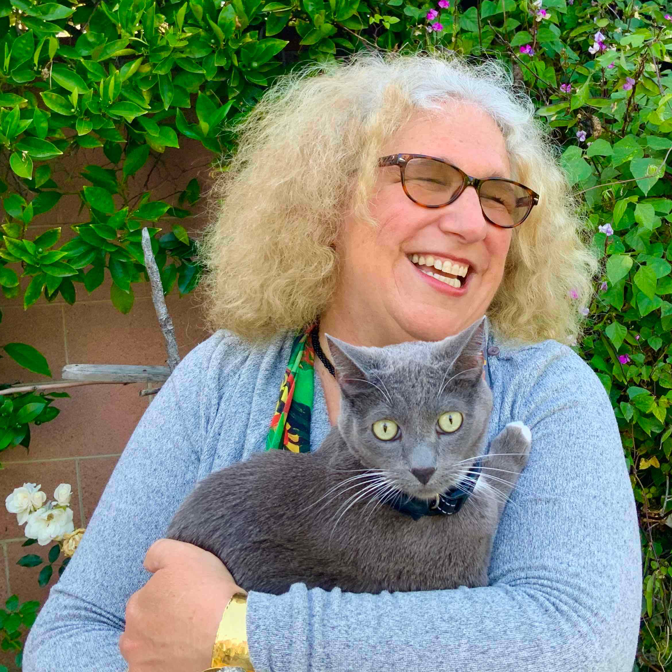 Mitzi holding a cat at a fun AAPI ceremony. Mitzi Schwarz - Wedding Officiant