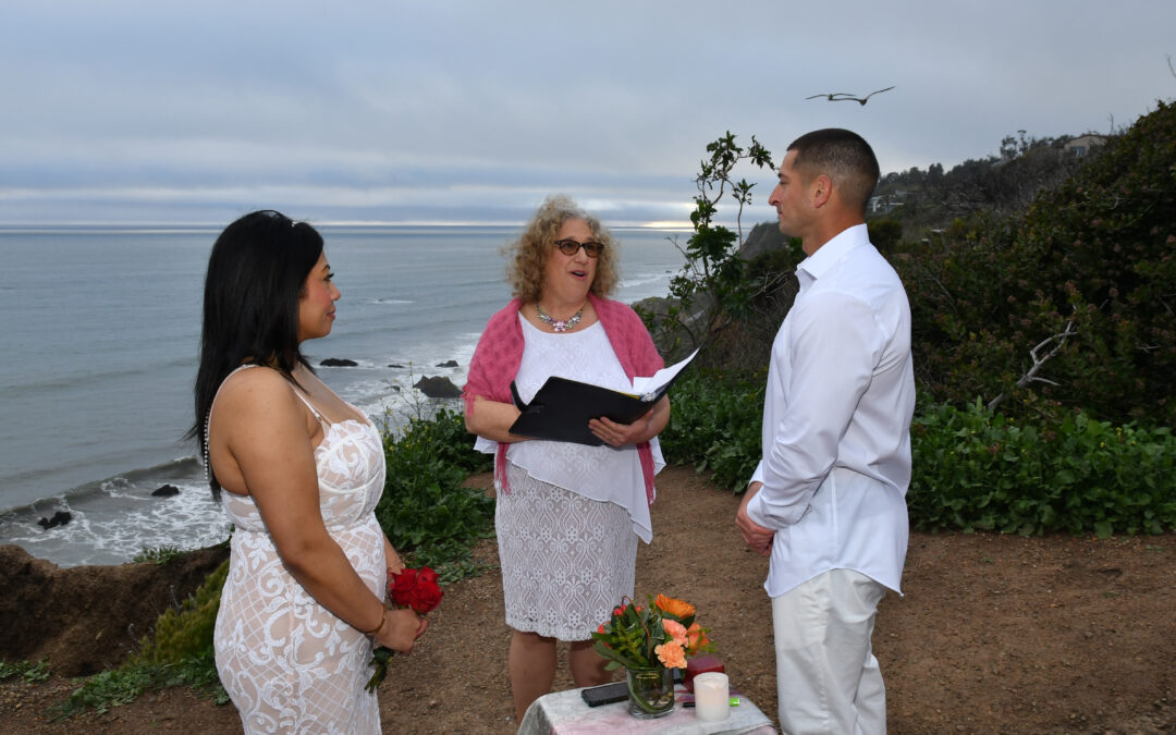 Chaplain Mitzi Schwarz officiating the Micro Wedding Ceremony of a Couple on the Beach